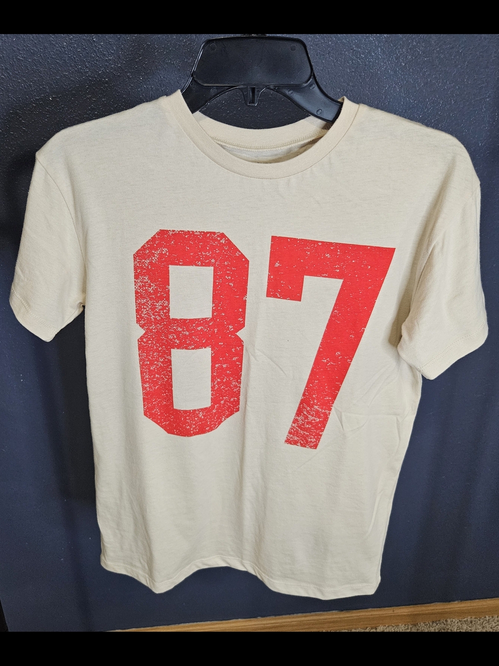 Never Been Worn Grayson Threads Cream Tee with Distressed Red '87' Graphic
